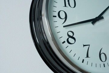 Close up of a wall clock showing eight o'clock in the morning