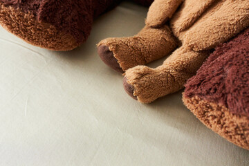 Close up of teddy bear lying on the bed with copy space