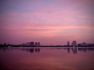 Dreamy rose-lavender dusk over West Lake, Hanoi &mdash; mirror-calm water and soft city lights (print, poster, web hero)
