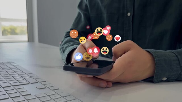 Person using smart phone with emoticon icons of Social Media.Digital marketing, social media, like, media, social network and scrolling concept.Interactive with friends on chat with emoticon feedback.