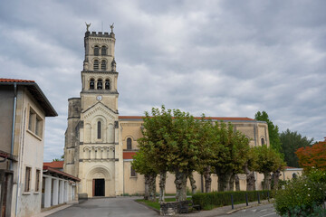 Fototapeta premium Explore the stunning architecture of the Basilica of Notre-Dame-de-Buglose, located in Saint-Vincent-de-Paul, Landes. The building showcases intricate designs against a moody sky.