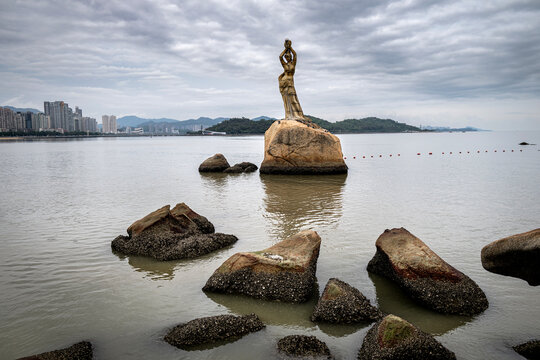 A striking statue of the Fisher Girl sits on a rock by Zhuhai's calm waters