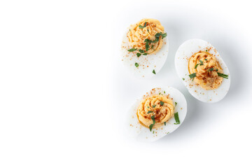 Homemade hard Boiled Deviled Eggs garnished with herbs isolated on white background. Top view