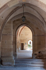 Cloister arches and vaulted ceilings, ribbed vault architecture, monastery corridors, stone arcades, medieval Cistercian abbey, historical interior, sacred place, symmetry, Maulbronn Monastery, UNESCO