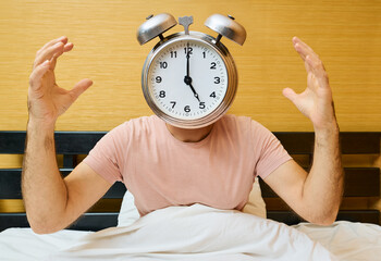 Shocked man with alarm clock instead of head has overslept. Lateness concept