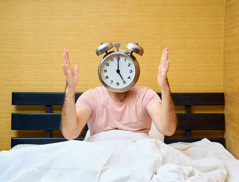 Shocked man with alarm clock instead of head has overslept. Lateness concept