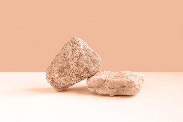 Stone Podium for promotion on beige Background. Natural rock pedestal. Two stone podiums. Beauty product mockup. Scene to show products. Showcase, display case. Front View, soft shadow.