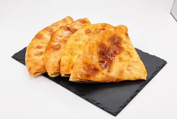 Golden Baked Lobiani Khachapuri Slices On Black Slate Plate, Appetizing Snack For Sharing, Warm And Crunchy
