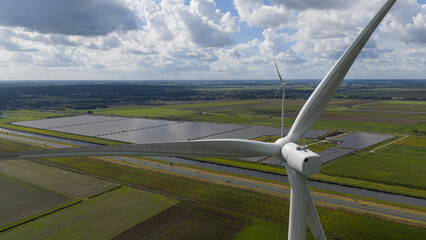 wind turbines and solar energy working together as complementary renewable sources, ensuring stable electricity supply
