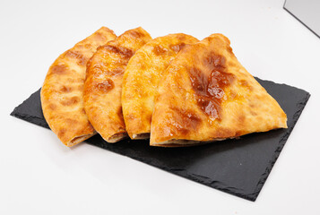 Golden Baked Lobiani Khachapuri Slices On Black Slate Plate, Appetizing Snack For Sharing, Warm And Crunchy