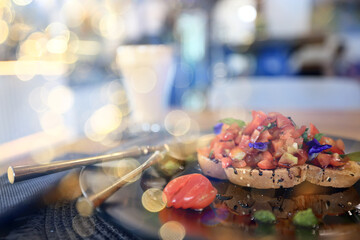 breakfast in the restaurant, table setting with fresh salad with fish, a delicate background of food on a plate