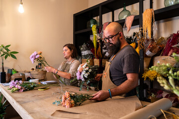Florist entrepreneurs arranging flowers in small business