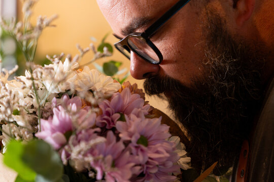 Florist smelling fresh bouquet in small business