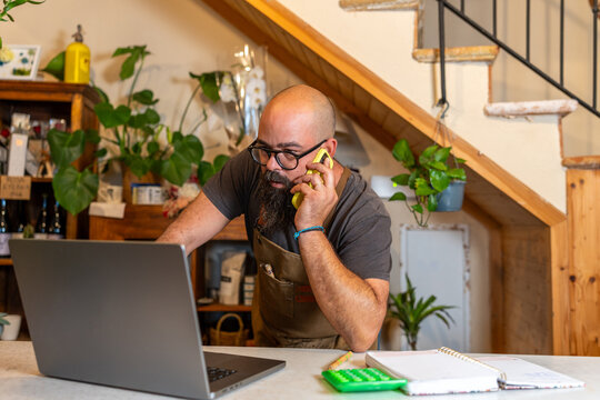 Florist entrepreneur managing small business receiving customer orders