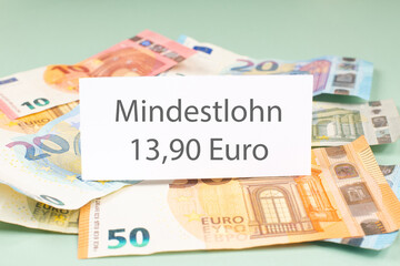 Minimum wage increase, Mindestlohn in german language, high living costs, workers and employees need higher income, inflation, expensive food and housing, social issue 