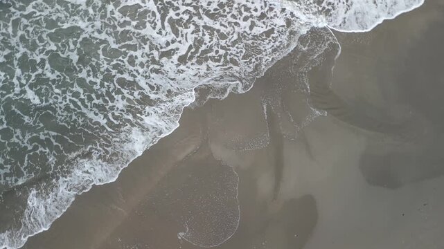 drone, vista su onde del mare sul bagnasciuga