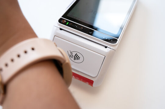 Smartwatch contactless payment at a modern terminal