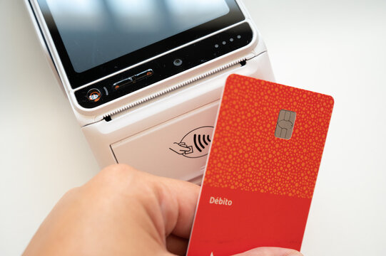 Hand making contactless debit card payment using POS terminal