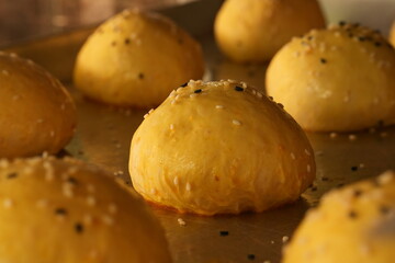 The sesame burger buns are undergoing final proofing before baking