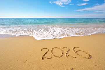 2026 text symbol of new year on the sea sand beach shore at daylight.