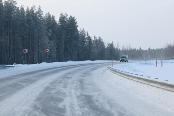Obraz premium empty winter road, snow background in the surrounding landscape