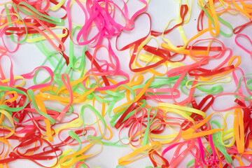 Neon Rubber Bands Cheerful Chaos with Vibrant Texture on White.