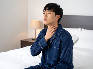 寝起きで喉が痛い男性