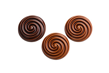 Three circular chocolate swirl candies with spiral pattern in brown tones, isolated on a transparent background