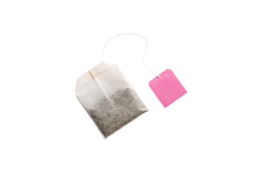 Tea bag lying flat with bright pink square tag connected by thin white string, isolated on a transparent background