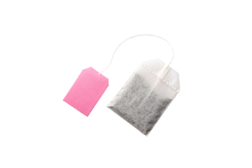 Tea bag with pink rectangular tag attached by white string for brewing hot beverages, isolated on a transparent background