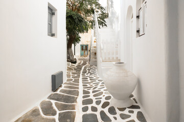 narrow street with traditional white houses in Chora, Mykonos, Greece. famous Greek architectural design. minimalist architectural background in white. Mykonos