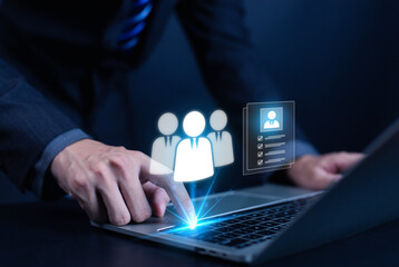 Businessman using laptop with virtual human resource management icons, representing recruitment, employee selection, digital HR system, online hiring process, and modern business technology concept.