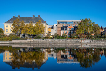 Motala Stream and Norrköping waterfront Saltängen during autumn. Norrköping is a historic industrial town in Sweden.