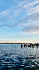 Calm Potomac waters and a blue sky over Woodrow Wilson Memorial Bridge and dock in Washington DC USA