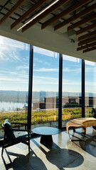 Bright modern lounge in D.C., USA with floor to ceiling windows overlooking river and skyline