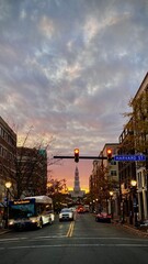 Street scene at sunset on Harvard Street with traffic and Capitol dome. Old Town Alexandria.