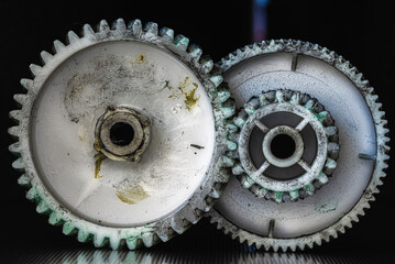 Worn plastic gears and cogs with food grade lubricant, showing texture and mechanical details
