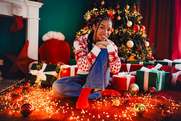 Playful Christmas scene with a smiling girl among gifts and a twinkling tree in a cozy home setting