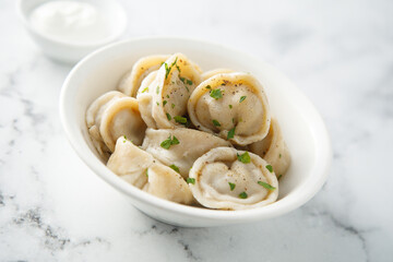 Russian dumplings served with sour cream