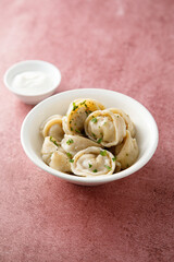 Russian dumplings served with sour cream