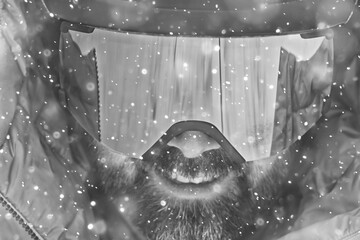 Man in ski helmet and glasses, snowfall extreme sports portrait close-up bearded cheerful