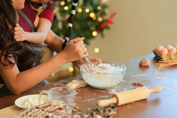 Family Moments. Mother and daughter baking together, creating holiday memories in a cozy kitchen.