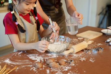 Baking Together: Mother and Daughter Making Holiday Cookies in Cozy Kitchen