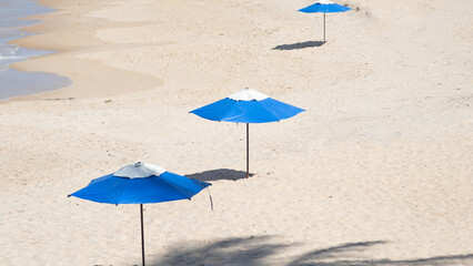 Blue Umbrellas on a Tranquil Beachfront Sand Dune