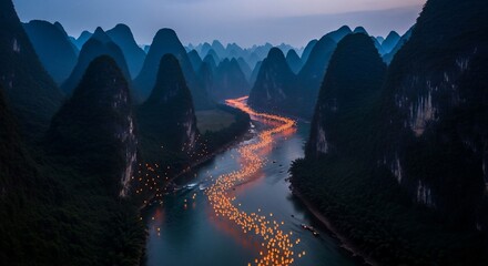 River of lighted lanterns between mountain peaks at dusk