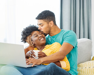 Portrait of a lovely young couple using a laptop  together at home