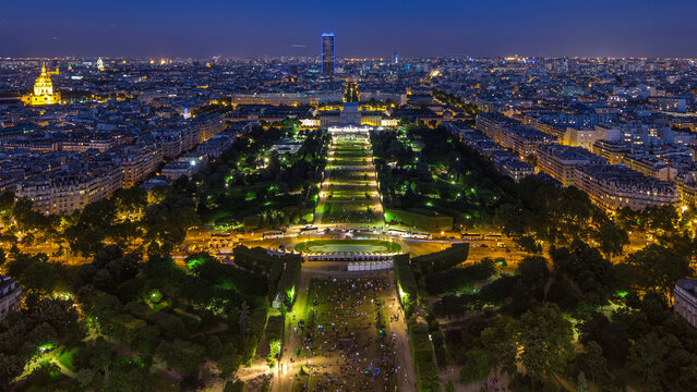 Aerial view of a large city skyline after sunset day to night timelapse. Top view from the Eiffel tower. Paris, France.