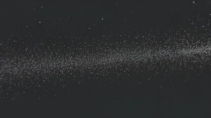 Opening sequence presenting dense white particle band flickering in void, creating ribbon pattern