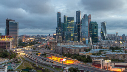 Fototapeta premium Night to day view of the city traffic timelapse and Building of Moscow International Business Center Moscow-City