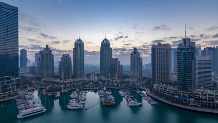 Obraz premium Aerial view of modern skyscrapers night to day timelapse before sunrise in Dubai Marina in Dubai, UAE.